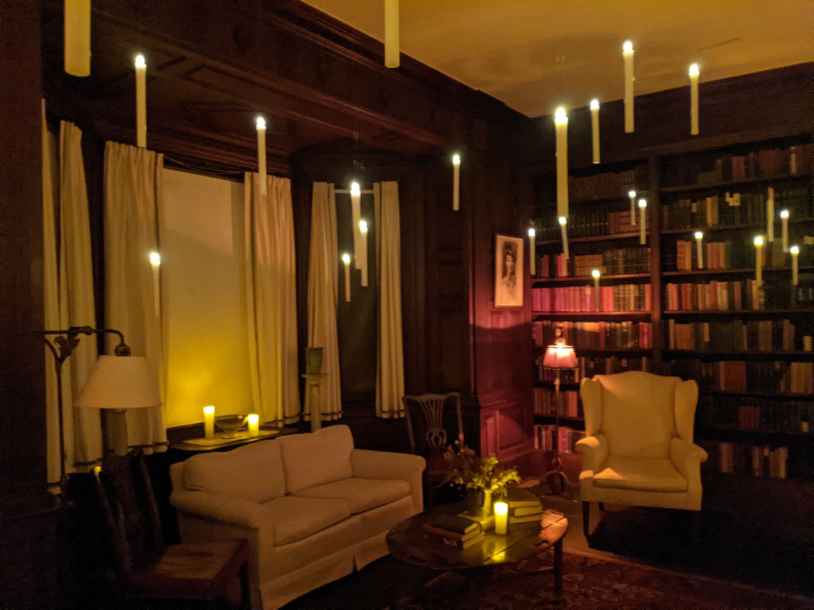 Candles float in a library